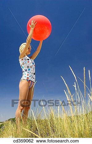 balance, blond, ball, Arms raised View Large Photo Image Stock Image - balance, blond, ball, Arms raised. Fotosearch