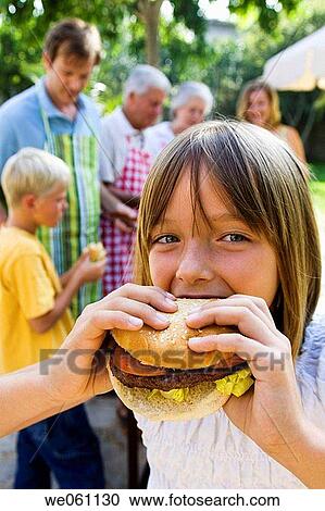 Stock Image - barbecue, barbeque, bbq, bite, biting, burger. Fotosearch