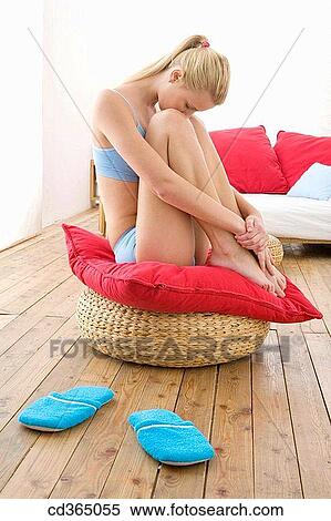 Stock Photography - barefoot, Body care, blond, at-home. Fotosearch