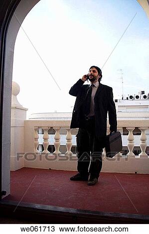 Stock Image - beard, business, briefcase, black hair, arch. Fotosearch
