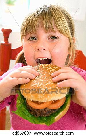 big, bite, biting, blond, burger, calorie View Large Photo Image Stock Photo - big, bite, biting, blond, burger, calorie. Fotosearch