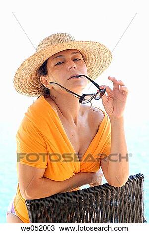 Stock Image - bite, biting, brunette, calm, chair. Fotosearch