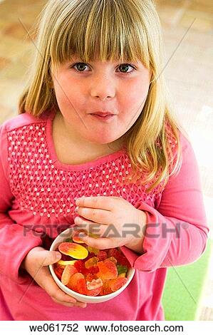 Stock Image - blond, bowl, candy, child, childhood. Fotosearch