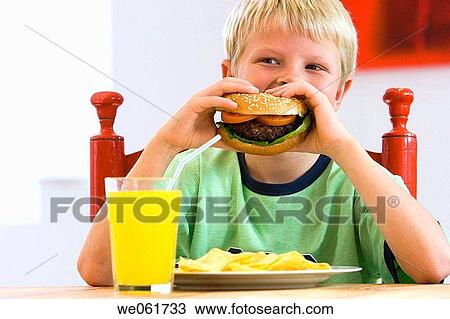 Stock Image - blond, boy, burger, calorie, child. Fotosearch