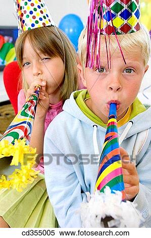 Stock Photography - blow, blowing, boy, brother, cap. Fotosearch
