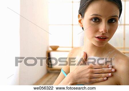 Stock Image - Body care, brunette, apply. Fotosearch