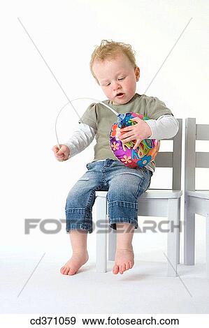 Stock Photo - boy, baby, blond, barefoot, balloon, 3-4 years. Fotosearch