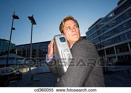 Stock Photography - briefcase, business, businessman, businesspeople, carry. Fotosearch