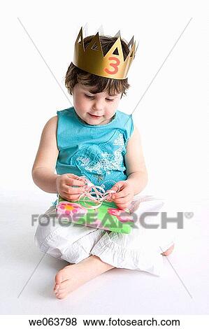 Stock Photo - brunette, baby, bow, birthday, barefoot, 3-4 years. Fotosearch