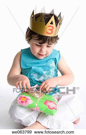 Stock Photo - brunette, baby, bow, birthday, barefoot, 3-4 years. Fotosearch