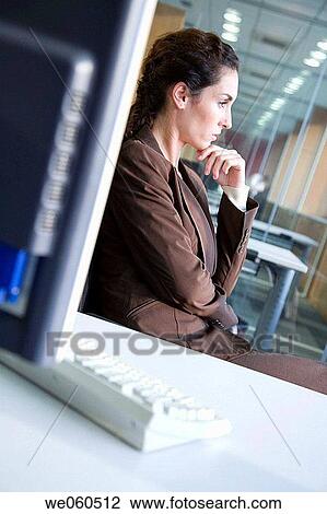 Stock Image - brunette, businesspeople, business, absorbed. Fotosearch