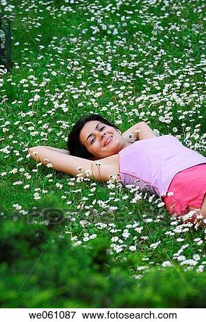 Stock Photo - brunette, calm, chilling out, chrysanthemum. Fotosearch