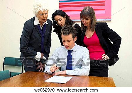 Business team checking the small print on a contract. View Large Photo Image Stock Image - Business team checking the small print on a contract.. Fotosearch