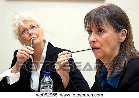Businesswomen thinking during a meeting. View Large Photo Image Stock Photography - Businesswomen thinking during a meeting.. Fotosearch
