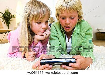 calm, addiction, brother, at-home, amusement, ability View Large Photo Image Stock Photography - calm, addiction, brother, at-home, amusement, ability. Fotosearch
