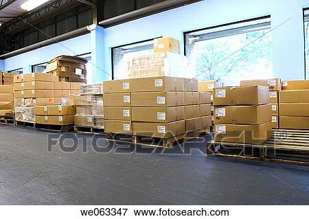 Cardboard boxes, on wooden pallets, arranged against the wall in a warehouse. View Large Photo Image Stock Photo - Cardboard boxes, on wooden pallets, arranged against the wall in a warehouse.. Fotosearch