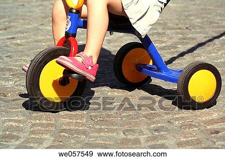 child on tricycle