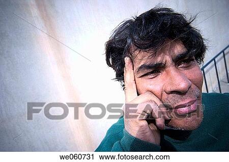 Stock Image - Close_up of a young Hispanic man posing. Fotosearch
