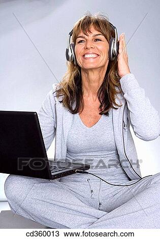 Stock Image - computer, contemporary, cross-legged. Fotosearch