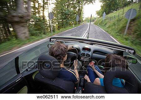 Stock Image - Couple in convertible car, Gipuzkoa, Euskadi. Spain.. Fotosearch