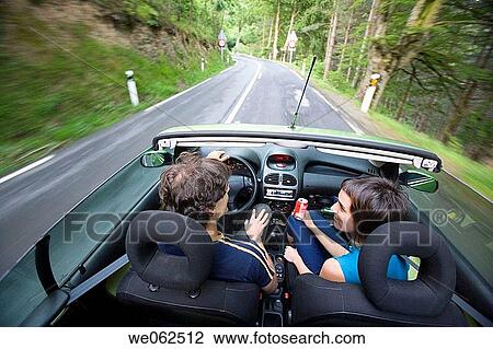 Stock Image - Couple in convertible car, Gipuzkoa, Euskadi. Spain.. Fotosearch