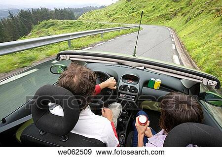 Stock Photo - Couple in convertible car, Gipuzkoa, Euskadi. Spain.. Fotosearch