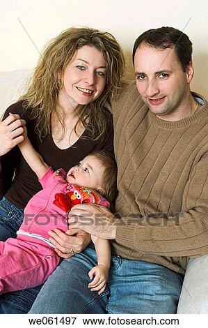 Couple posing with their toddler daughter View Large Photo Image Stock Photo - Couple posing with their toddler daughter. Fotosearch