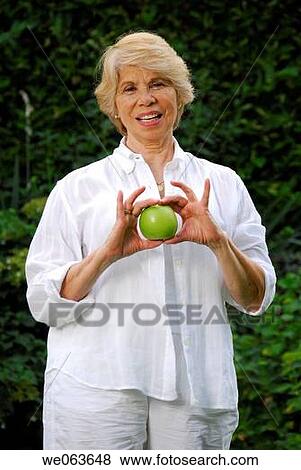 Stock Photo - day, Female, Facial expression, apple. Fotosearch