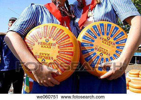 Stock Image - Farmhands with cheese rolls on cheese market, Kaasmarkt, Gouda, Holland, Netherlands. Fotosearch