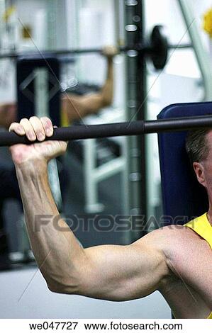 Free weight barbell shoulder press exercise, Abu Dhabi, United Arab Emirates View Large Photo Image Stock Photo - Free weight barbell shoulder press exercise, Abu Dhabi, United Arab Emirates. Fotosearch