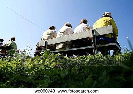 Group of people sitting on bank on dike, Sail 05, Amsterdam, IJ haven, Holland, Netherlands View Large Photo Image Stock Image - Group of people sitting on bank on dike, Sail 05, Amsterdam, IJ haven, Holland, Netherlands. Fotosearch