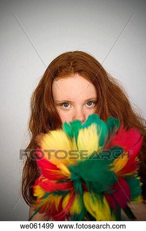 Stock Photo - Long red_hair teen girl holding a feather duster. Fotosearch