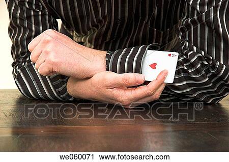 Man pulls the Ace of Hearts playing card from his shirt sleeve. View Large Photo Image Stock Image - Man pulls the Ace of Hearts playing card from his shirt sleeve.. Fotosearch