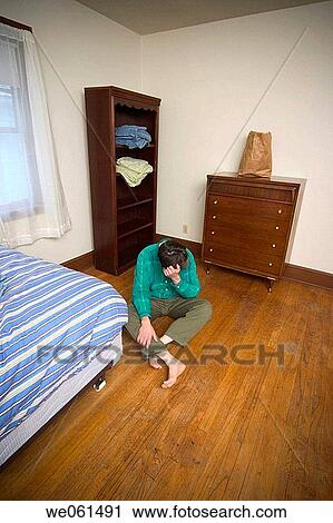 Man sitting on the floor in his bedroom View Large Photo Image Stock Image - Man sitting on the floor in his bedroom. Fotosearch