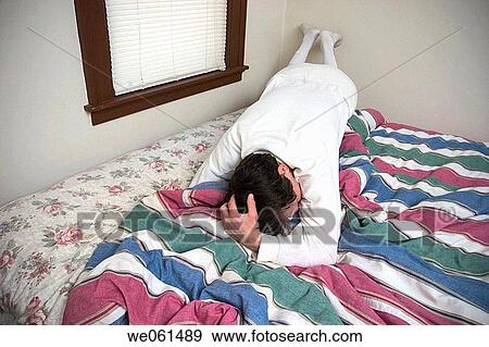 Man wearing long underwear lying on his bed View Large Photo Image Stock Photo - Man wearing long underwear lying on his bed. Fotosearch