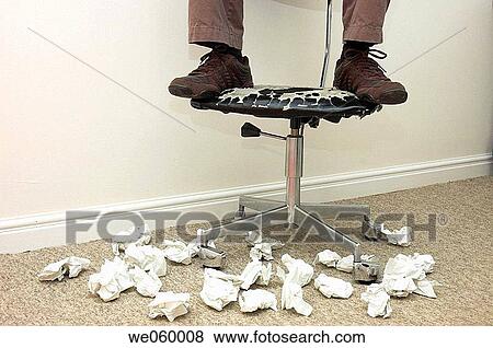 Man's feet on battered office chair surrounded by crumpled paper. View Large Photo Image Stock Photo - Man's feet on battered office chair surrounded by crumpled paper.. Fotosearch