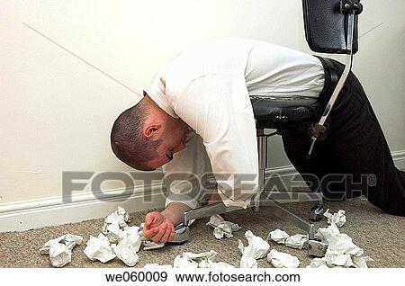 Man's slumped over an old battered office chair surrounded by crumpled paper. View Large Photo Image Stock Photo - Man's slumped over an old battered office chair surrounded by crumpled paper.. Fotosearch