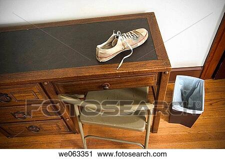 Man's sneaker on top of a desk in a bedroom. View Large Photo Image Stock Image - Man's sneaker on top of a desk in a bedroom.. Fotosearch