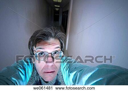 Middle_age man, wearing glasses, posing in a long hallway View Large Photo Image Stock Image - Middle_age man, wearing glasses, posing in a long hallway. Fotosearch
