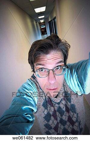 Middle_age man, wearing glasses, posing in a long hallway View Large Photo Image Stock Image - Middle_age man, wearing glasses, posing in a long hallway. Fotosearch