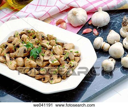 Stock Image - Mushrooms in garlic sauce. Fotosearch