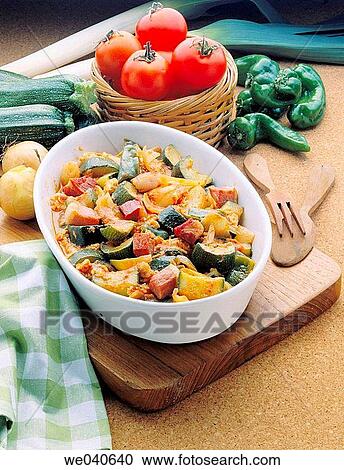 Stock Image - ? Pisto? Spanish dish made of tomatoes, onions, eggplant or courgettes, green and red peppers and olive oil. Fotosearch