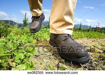 Stock Photography - Protective boots, field. Fotosearch