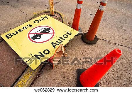 Sign laying on the ground near some traffic cones reading,? BUSES ONLY, NO AUTOS?. View Large Photo Image Stock Photo - Sign laying on the ground near some traffic cones reading,? BUSES ONLY, NO AUTOS?.. Fotosearch