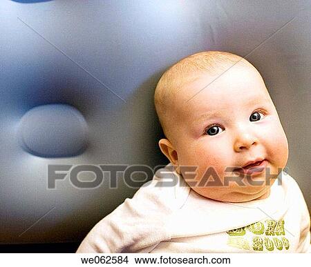 Picture - Six-month-old baby looking at the camera. Fotosearch