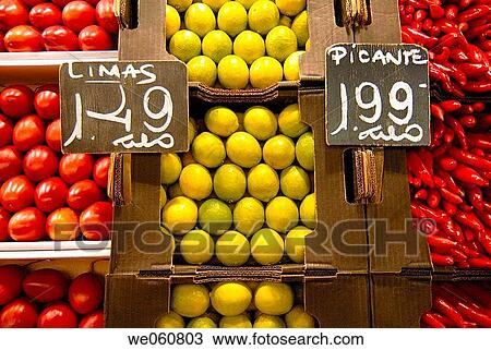 Stock Image - Southamerican products, tamarillos, limes and red hot peppers. La Boquer? a market. Barcelona. Spain.. Fotosearch