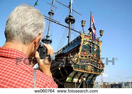 Tourist filming sailing ship Prins Willem on Sail 05, Veemkade, Amsterdam, Ijhaven, Holland, Netherlands View Large Photo Image Picture - Tourist filming sailing ship Prins Willem on Sail 05, Veemkade, Amsterdam, Ijhaven, Holland, Netherlands. Fotosearch