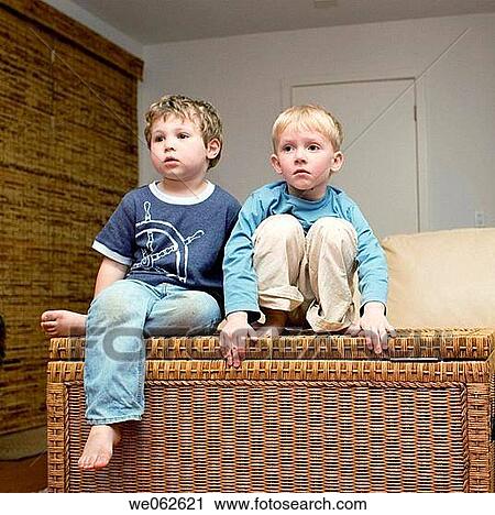 Stock Image - Two four-year-old boys watching television.. Fotosearch