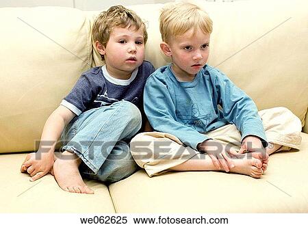 Two four-year-old boys watching television. View Large Photo Image Stock Photography - Two four-year-old boys watching television.. Fotosearch
