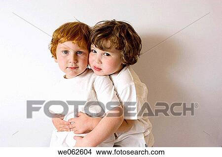 Picture - Two three-year-old boys hugging. Fotosearch